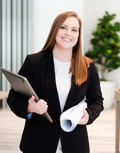 Whitney Holding Laptop and Blueprint