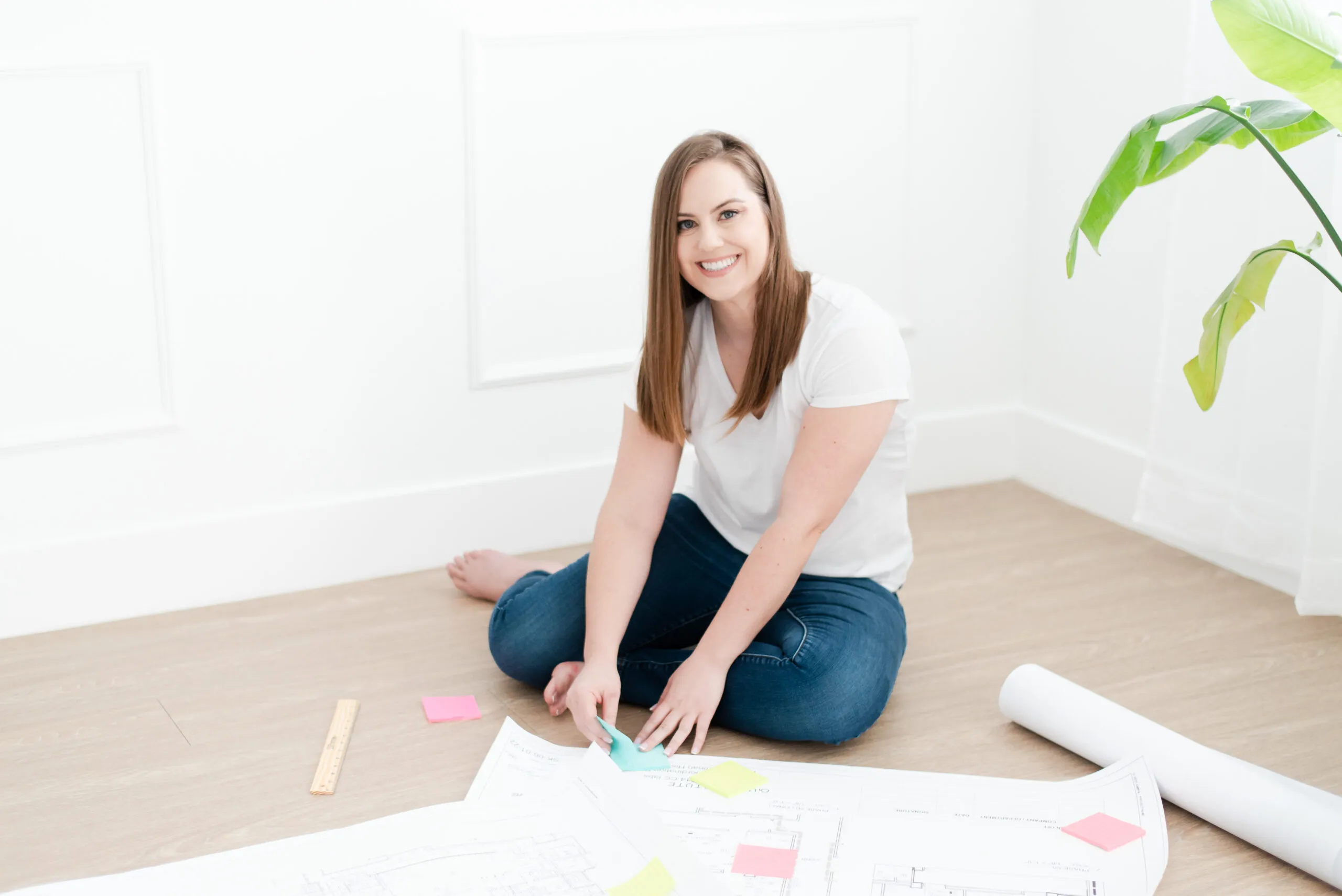 Whitney Sitting on Floor Placing Sticky Notes on Blueprint Whitney Sitting on Floor Placing Sticky Notes on Blueprint