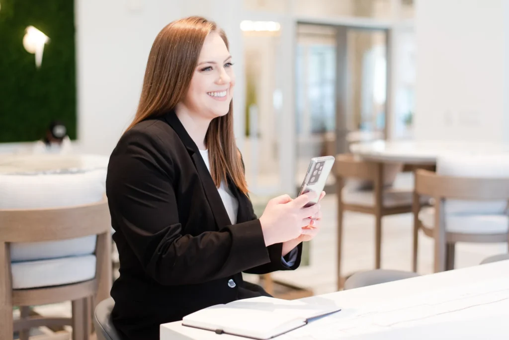 Whitney Goulish on a phone ready to schedule an free consultation