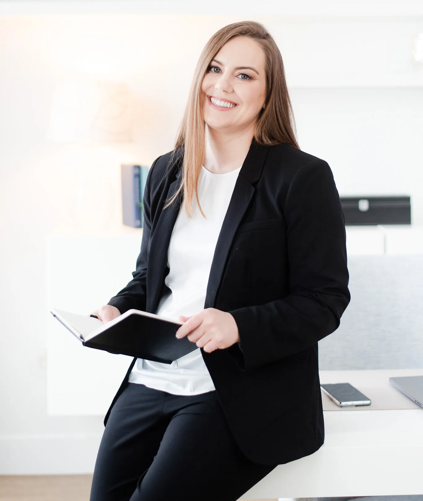 Whitney-Blk-Suit-Holding-Book-M-Suarez-Photography-189_cropped Whitney in Black Suit Leaning on Desk Holding Book