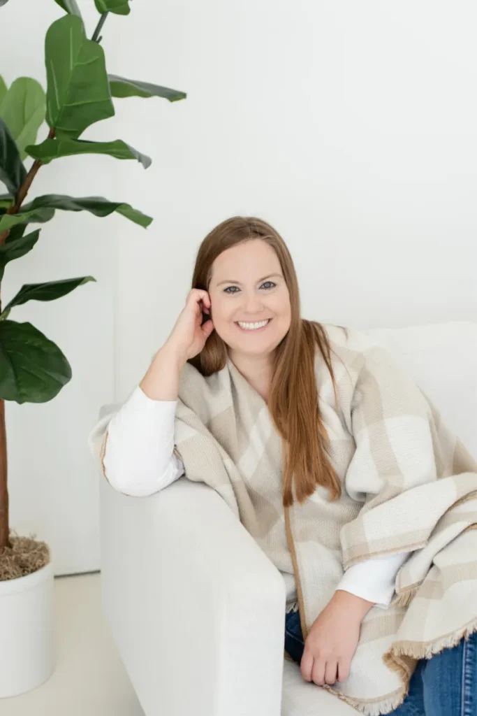 Whitney Goulish, President & Founder sitting on a couch