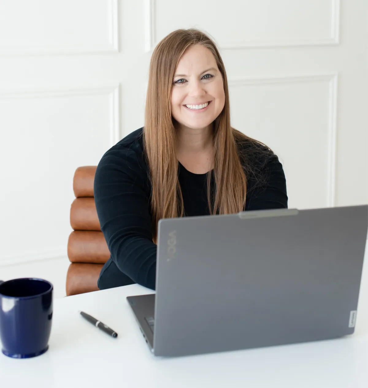 Whitney in Black Shirt Working on Laptop at Desk Whitney in Black Shirt Working on Laptop at Desk