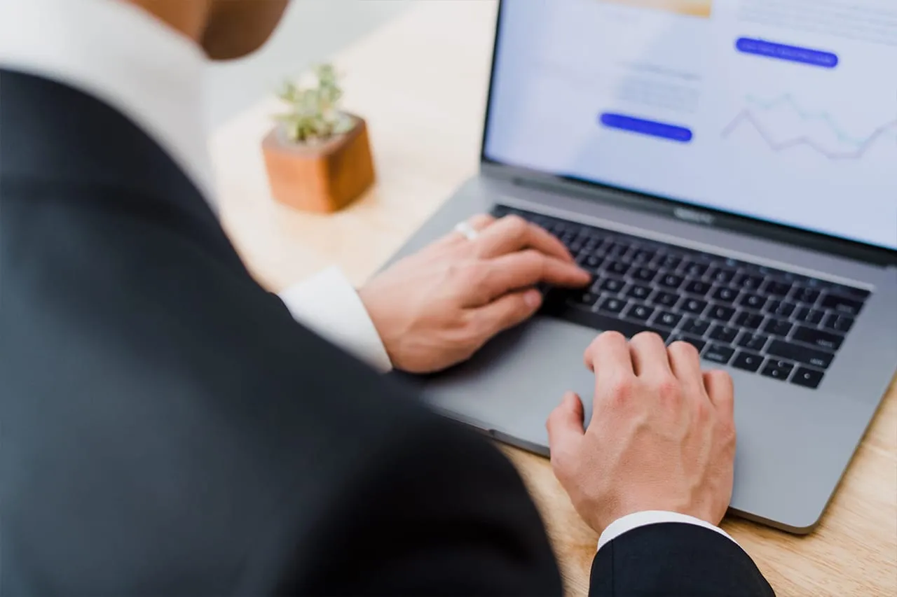 Man working on a laptop at a desk.