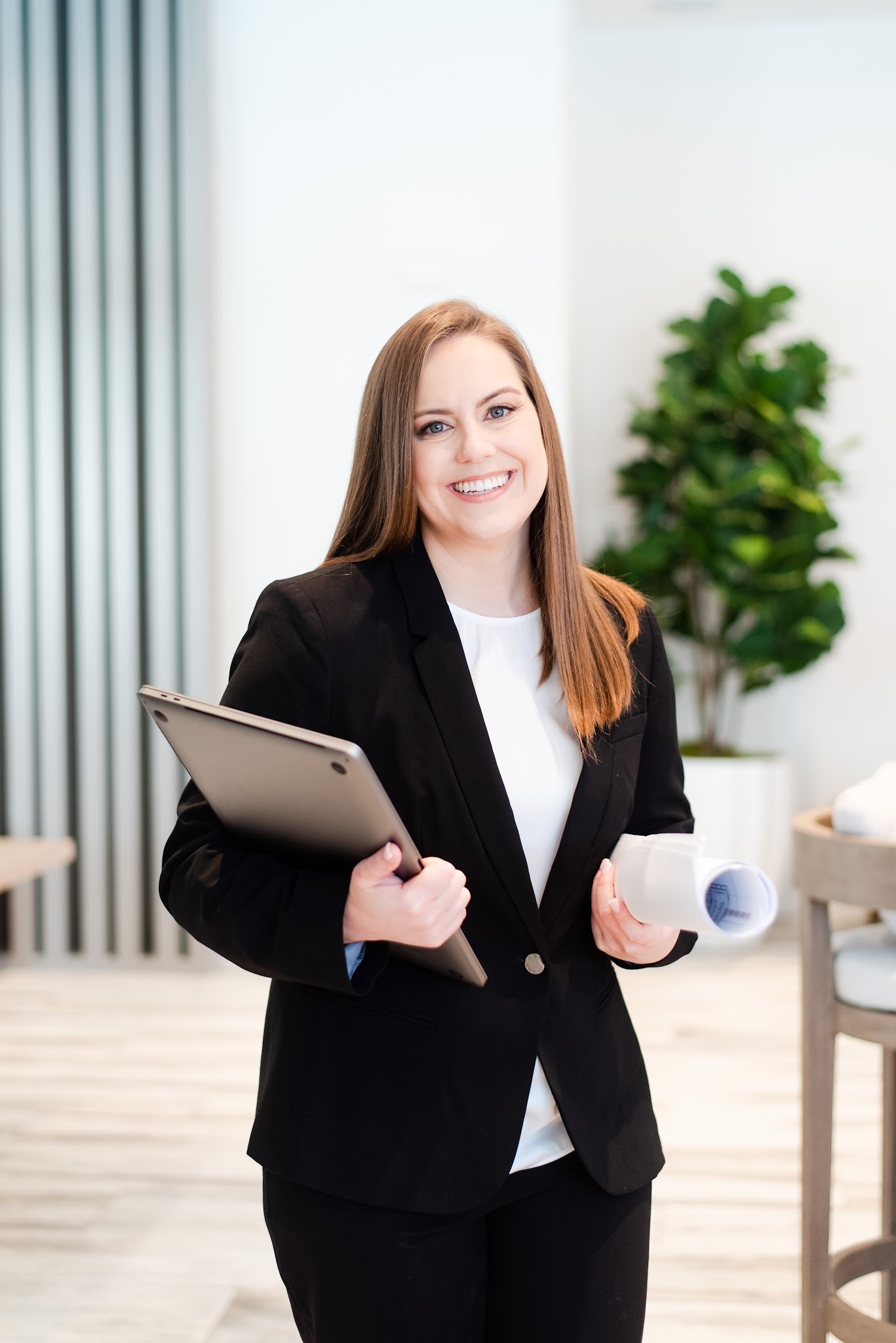 Whitney in Black Suit Holding Laptop and Blueprint Whitney in Black Suit Holding Laptop and Blueprint