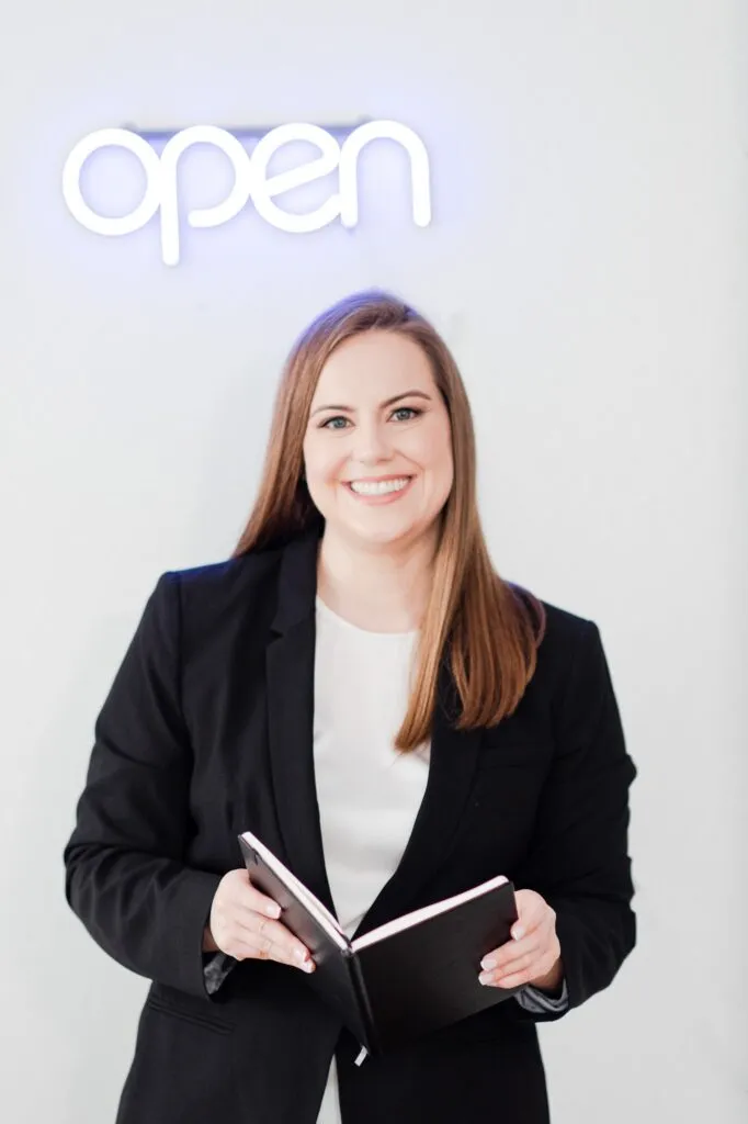 Whitney Black Suit Holding Open Book