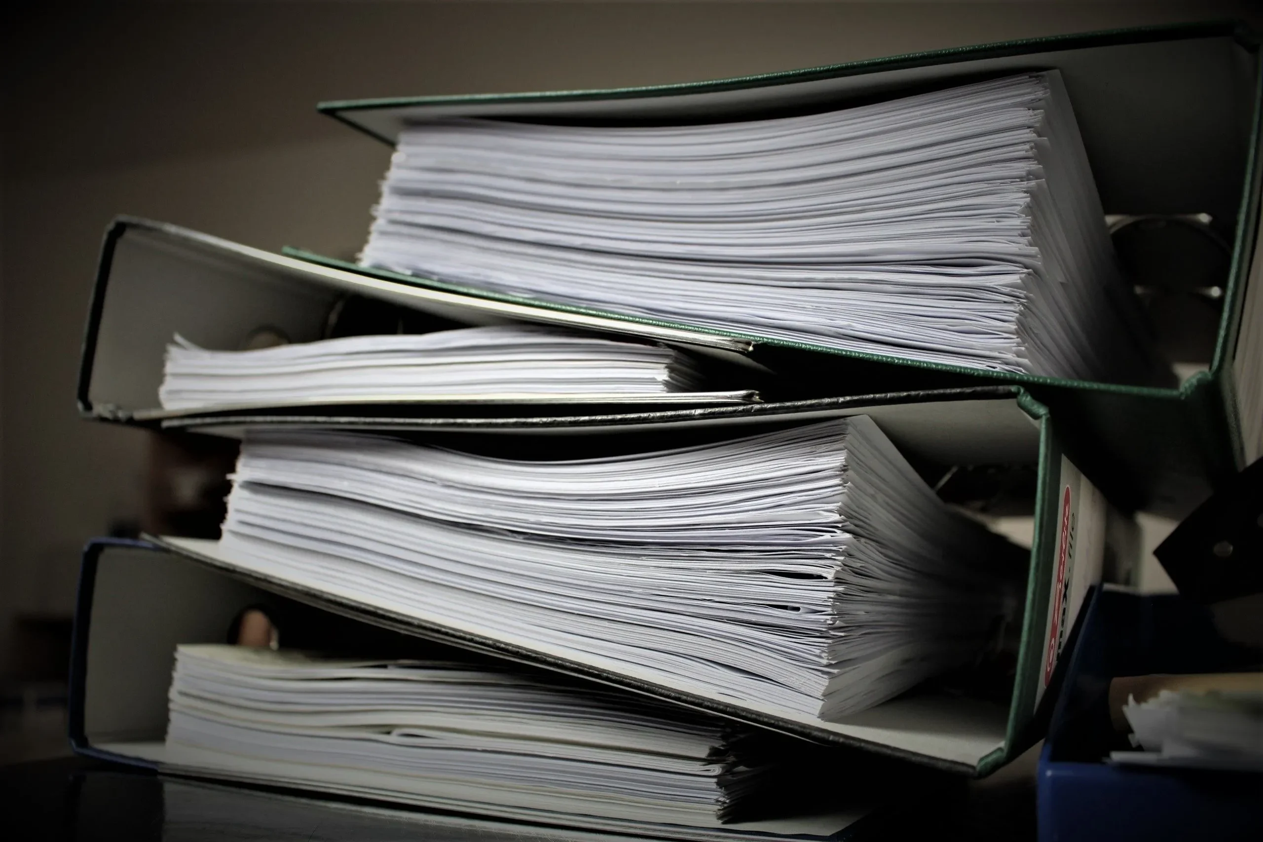 Close-up of Stacked Binders Possibly Filled with Policies and Procedures