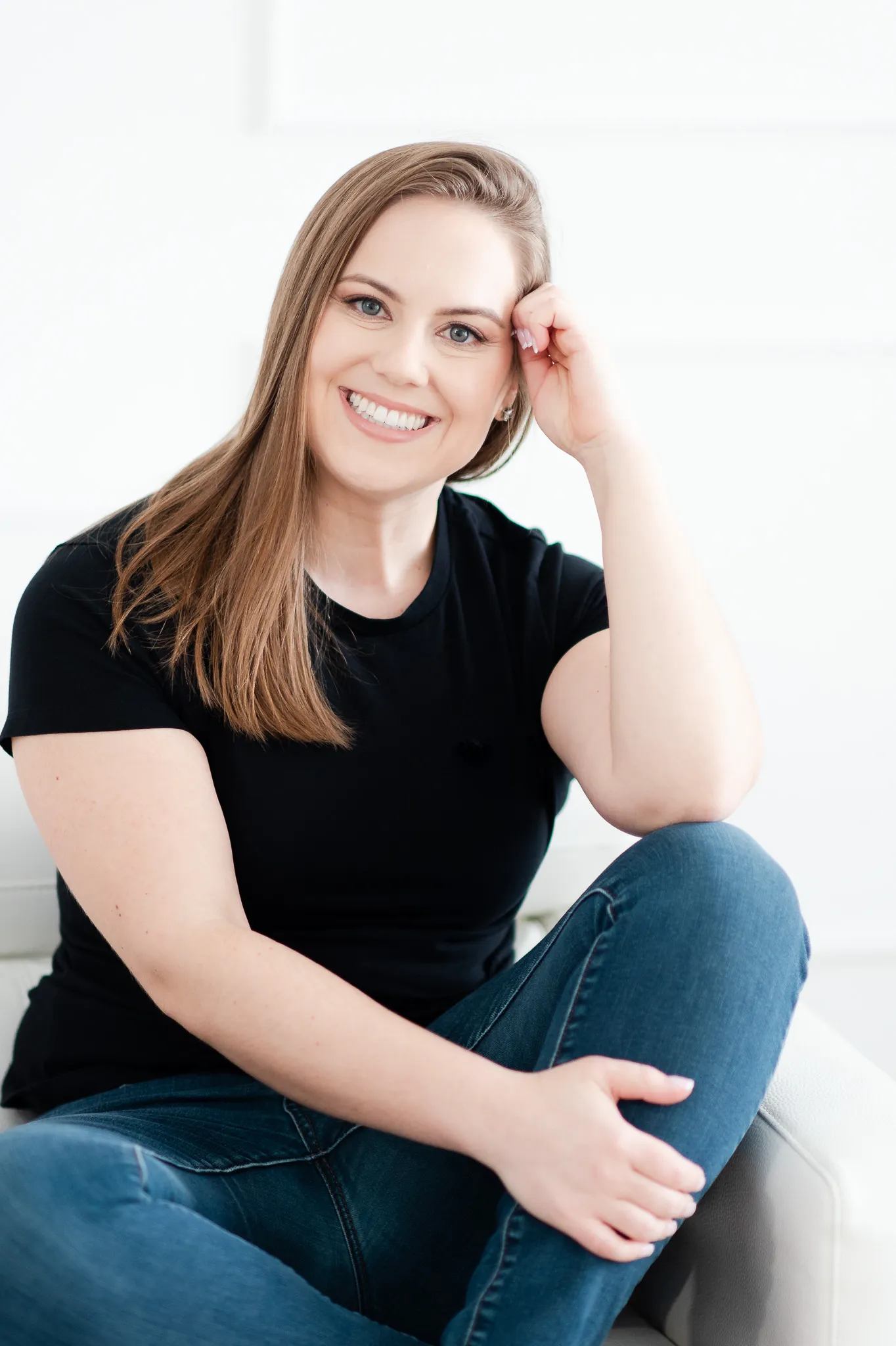 Whitney in Black Shirt and Jeans Sitting Casually
