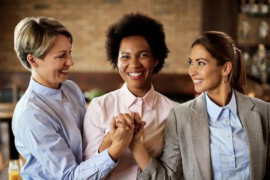 3 Women Holding Hands in Agreement