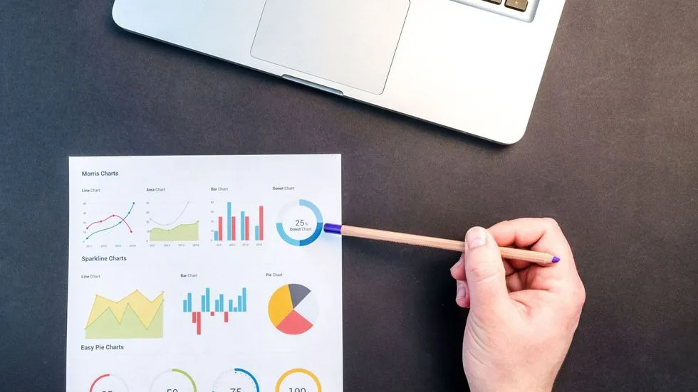 Hand Pointing to a Variety of Graphs on a Paper