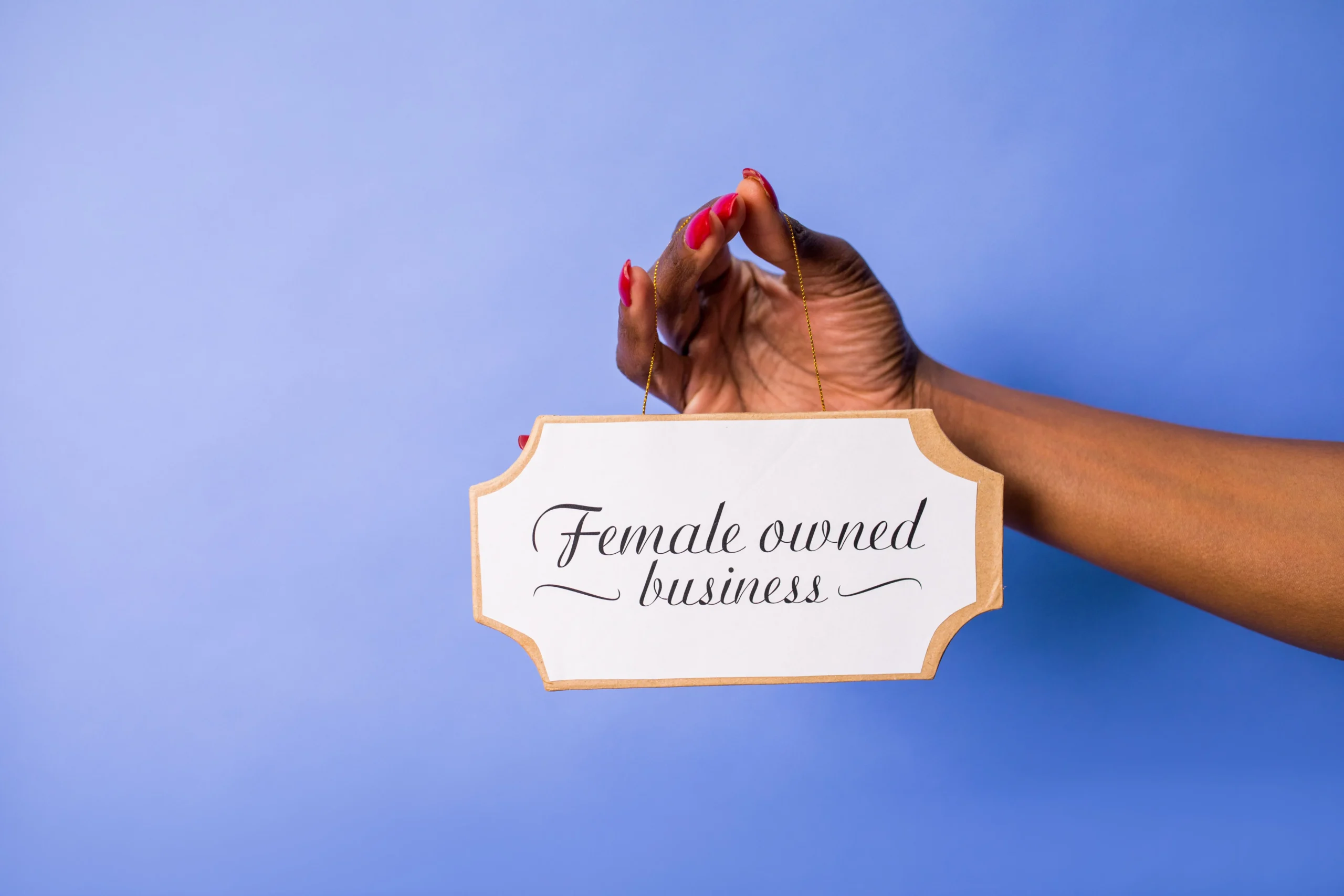 Women in Business Arm Holding Sign